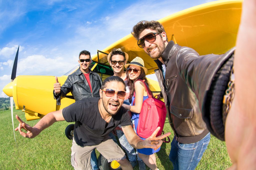 best friends taking selfie at aeroclub with ultra light airplane